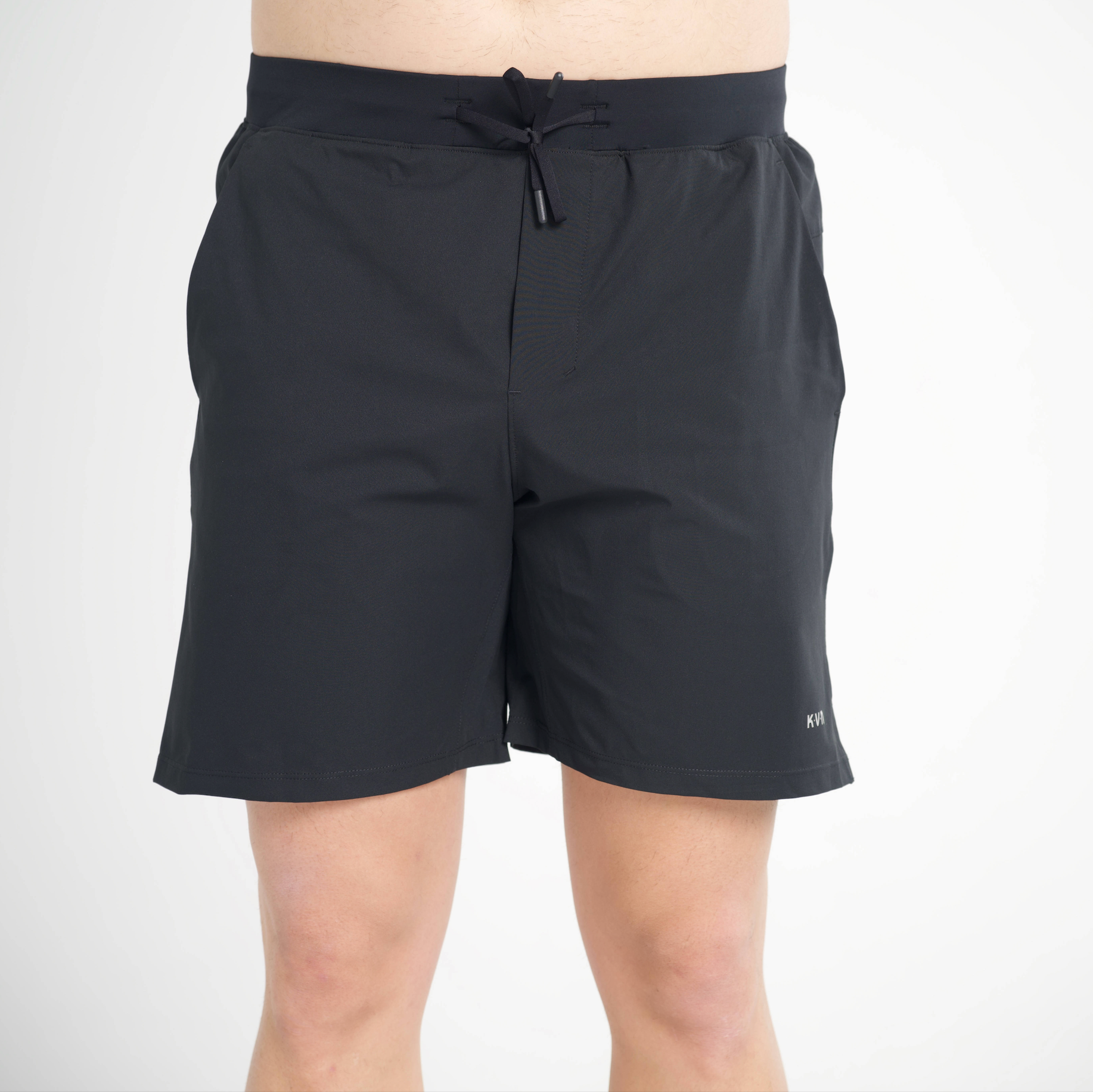 Black shorts with a drawstring on a white background