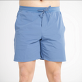 Blue shorts worn by a person on a white background