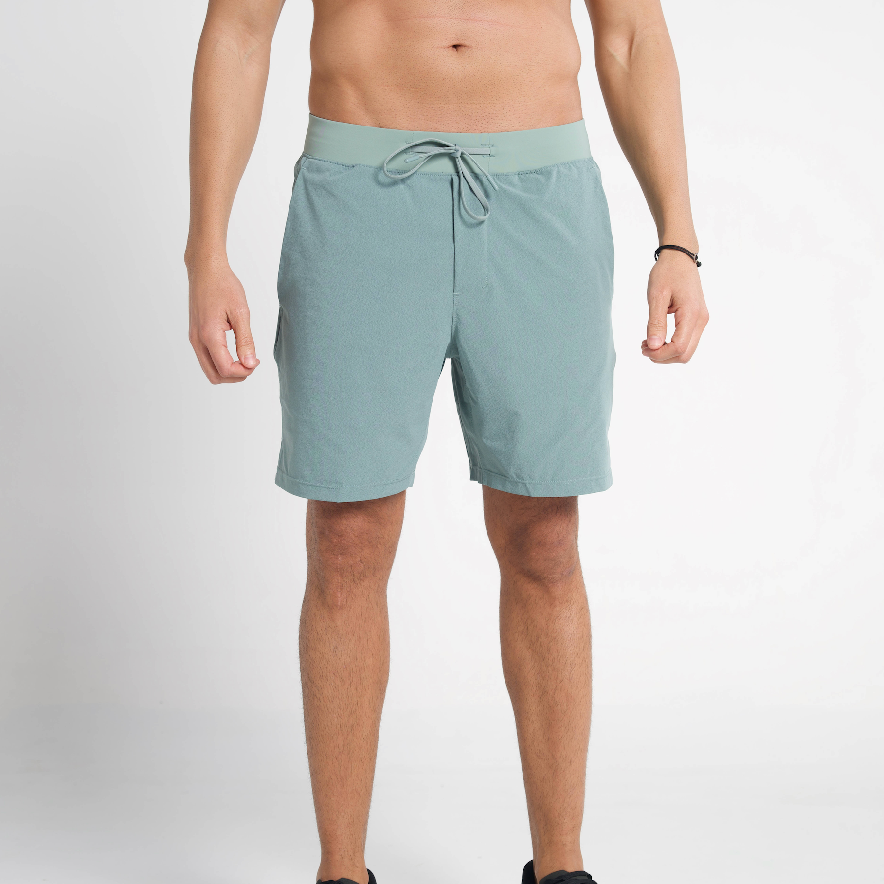 Person wearing light blue shorts on a plain background