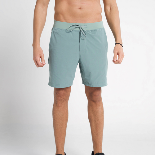Person wearing light blue shorts on a plain background