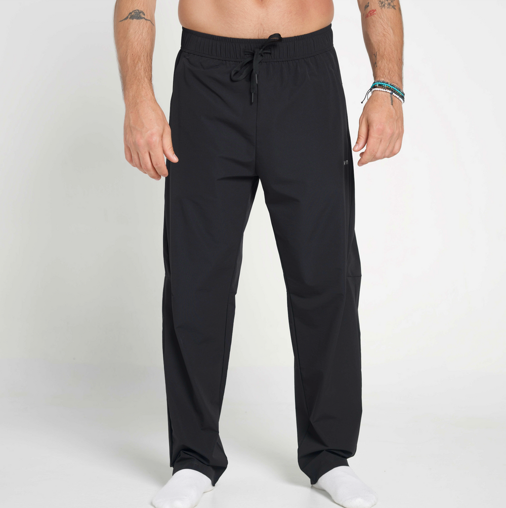 Black pants worn by a person on a white background