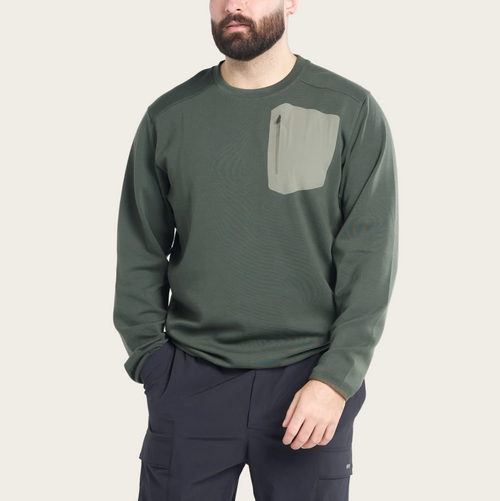 Man wearing a green long-sleeve shirt with a pocket on a white background