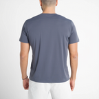 Person wearing a plain gray t-shirt on a white background