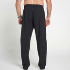 Black pants worn by a person on a white background